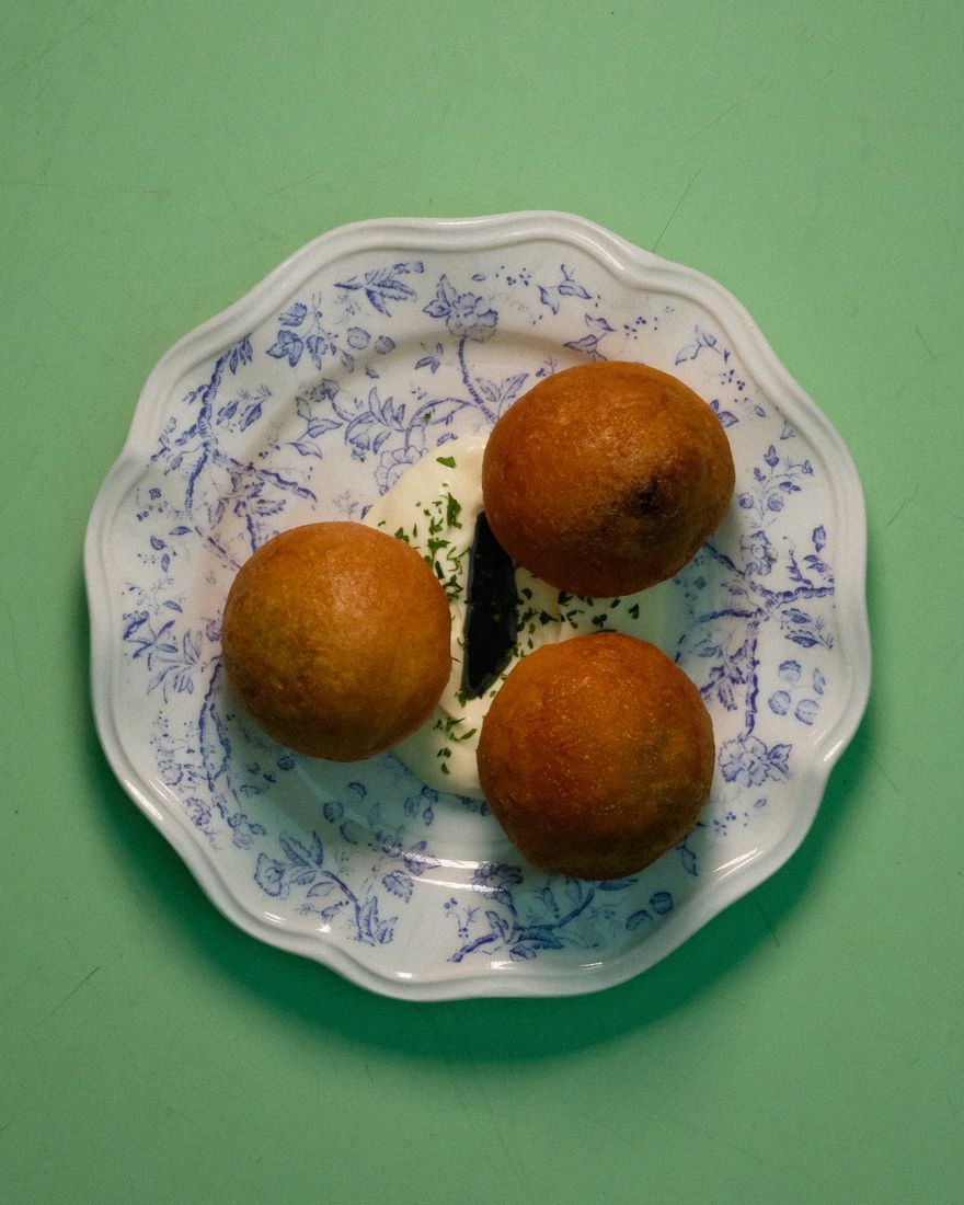 Three beignets stuffed with mushroom duxelles, on sour cream and parsley oil