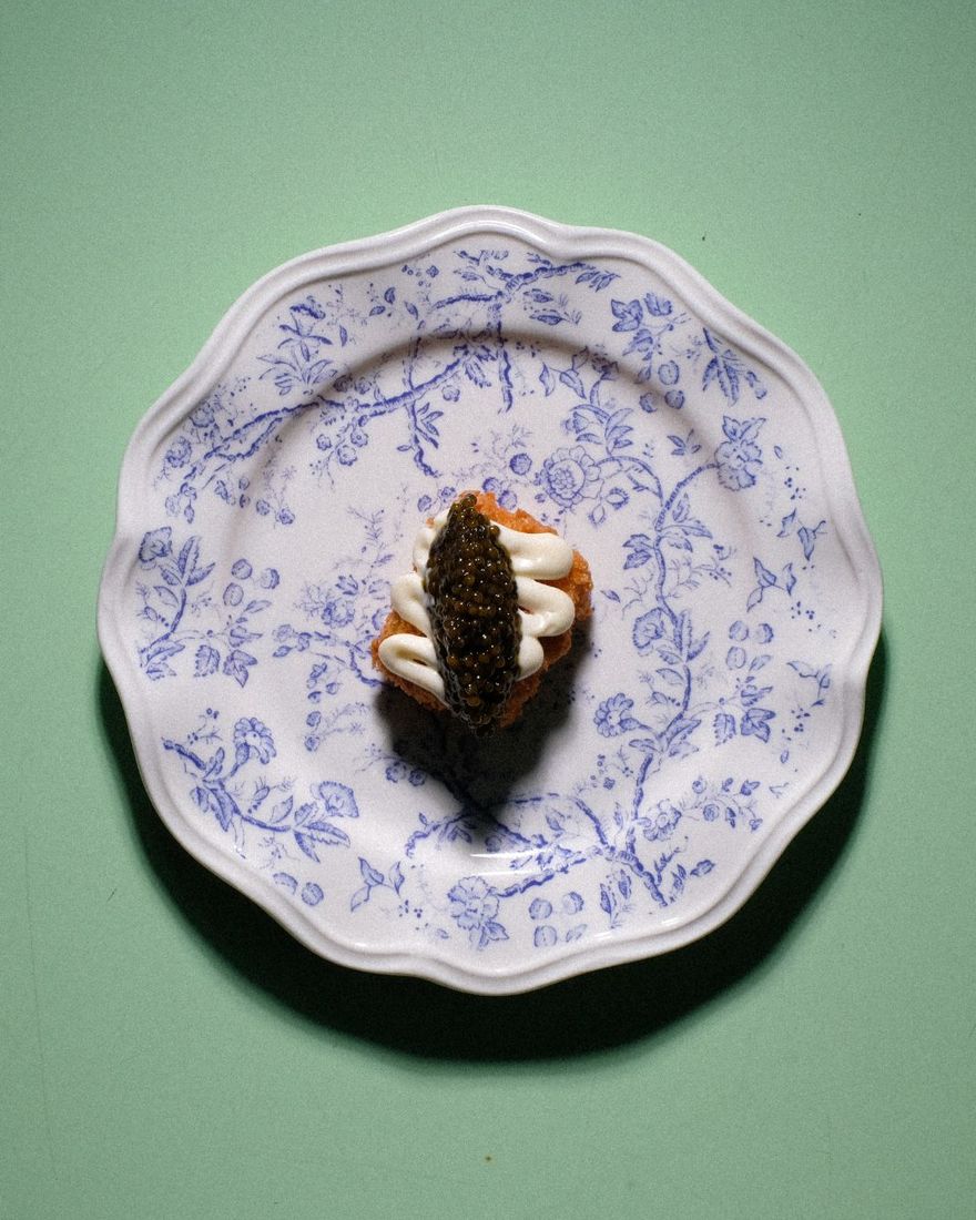 Caviar Kaviari Baenki on a crisp hashbrown with [CUISINE] kewpie, on a blue floral plate